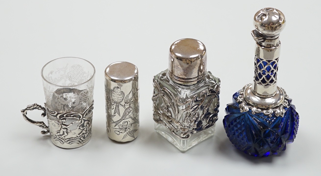 A late Victorian aesthetic engraved silver cylindrical scent bottle, by Sampson Mordan, London, 1881, 54mm, two other mounted glass scent bottles and a similar silver mounted demi tasse cup.